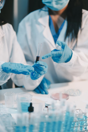 Research, experiment and medical trial being done by a scientist in a lab, science facility or hospital. One young, serious and professional researcher organizing, sorting or making a discoveryの写真素材