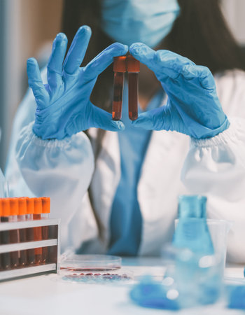 Research, experiment and medical trial being done by a scientist in a lab, science facility or hospital. One young, serious and professional researcher organizing, sorting or making a discoveryの写真素材