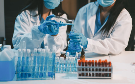 Research, experiment and medical trial being done by a scientist in a lab, science facility or hospital. One young, serious and professional researcher organizing, sorting or making a discoveryの写真素材