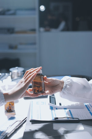 Male and female doctors are having a meeting in a hospital room.の写真素材