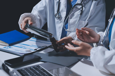 Male and female doctors are having a meeting in a hospital room.