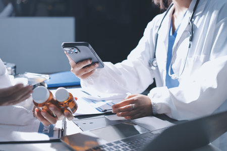 Male and female doctors are having a meeting in a hospital room.の写真素材