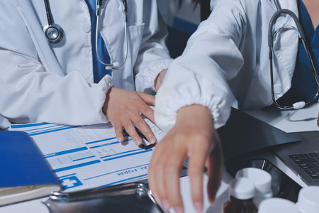 Male and female doctors are having a meeting in a hospital room.の写真素材