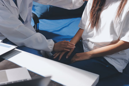 The doctor is checking and encouraging the patient.