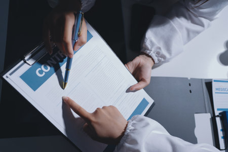 Male and female doctors are having a meeting in a hospital room.の写真素材