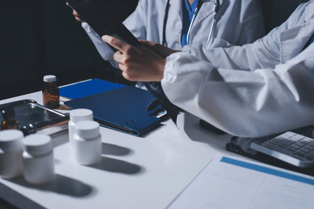 Male and female doctors are having a meeting in a hospital room.の写真素材