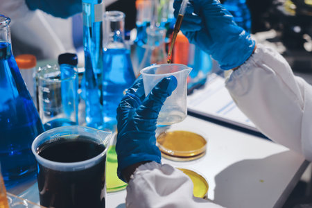 Scientist pipetting medical samples into microplate in laboratoryの写真素材