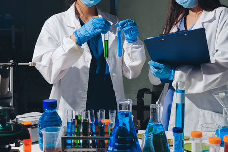 Scientist pipetting medical samples into microplate in laboratory