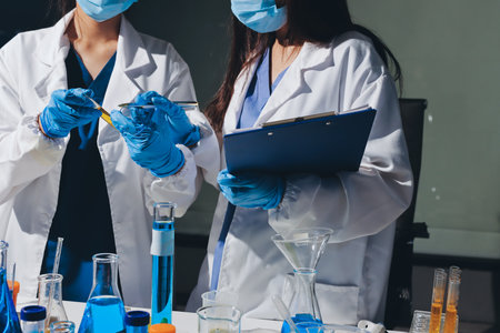 Scientist pipetting medical samples into microplate in laboratoryの写真素材
