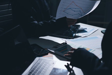 Group of business women working on a financial data expenses document.