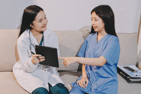 A doctor uses a stethoscope to check the heartbeat of his patient. Patients must undergo a yearly check-up for their health or a check-up from a cardiologist.の写真素材