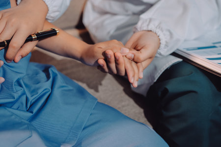 Doctor reassuring patient woman while sitting at the desk in clinic, just hands. Medicine and best...