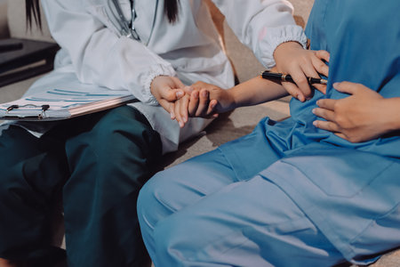Doctor reassuring patient woman while sitting at the desk in clinic, just hands. Medicine and best serviceの写真素材