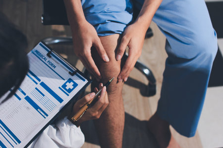 Physical therapist teaching a patient how to do exercises for his knee painの写真素材