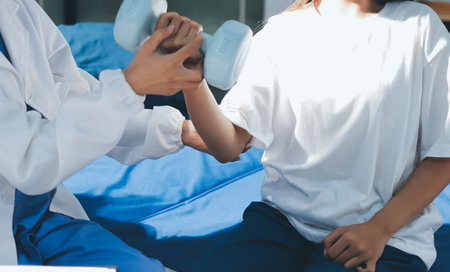 Unrecognizable uses blue hand weight during physical therapy session