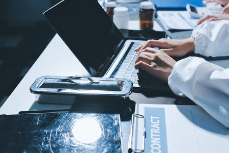 Male and female doctors are having a meeting in a hospital room.