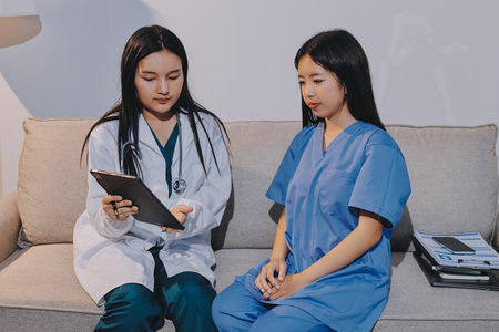 A doctor uses a stethoscope to check the heartbeat of his patient. Patients must undergo a yearly check-up for their health or a check-up from a cardiologist.の写真素材