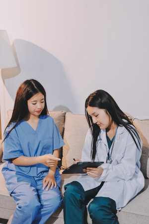 A doctor uses a stethoscope to check the heartbeat of his patient. Patients must undergo a yearly check-up for their health or a check-up from a cardiologist.の写真素材