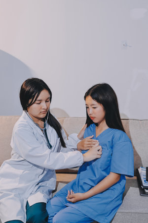 A doctor uses a stethoscope to check the heartbeat of his patient. Patients must undergo a yearly check-up for their health or a check-up from a cardiologist.の写真素材