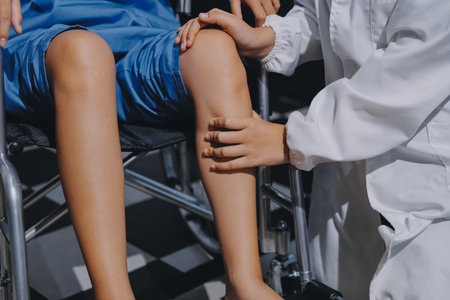 Physiotherapist checking knee of patient stockの写真素材