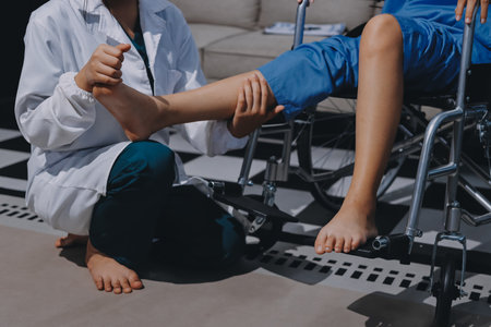 Physiotherapist checking knee of female patient stockの写真素材