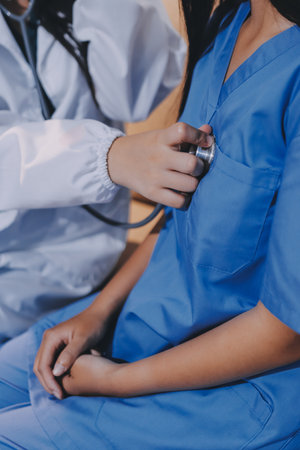 A doctor uses a stethoscope to check the heartbeat of his patient. Patients must undergo a yearly check-up for their health or a check-up from a cardiologist.の写真素材