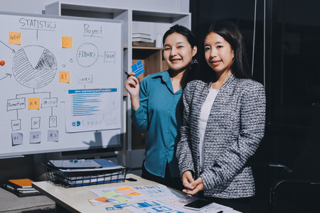 Group of young application developers analyzing uxui mobile app templates during a working meetingの写真素材