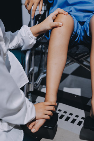 Physiotherapist checking knee of female patient stockの写真素材