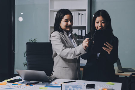 Accounting company provide finance and taxation planning for profitable cash flow, Auditor and accountant team working in office, analyze financial data and accounting record with calculator.Insightの写真素材