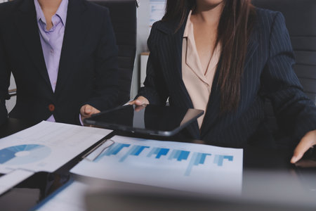 Team of business people working together in the meeting room office,
teamwork background charts and graphs banner, double exposure successful teamwork,business planning concept.の写真素材