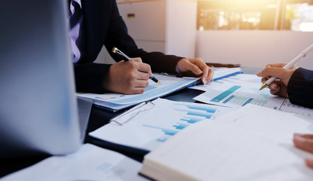 Team of business people working together in the meeting room office,
teamwork background charts and graphs banner, double exposure successful teamwork,business planning concept.の写真素材
