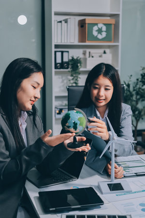 Business team people planning and discussing on recycle reduce reuse policy symbol in office meeting room.の写真素材