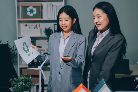 Business team people planning and discussing on recycle reduce reuse policy symbol in office meeting room.の写真素材