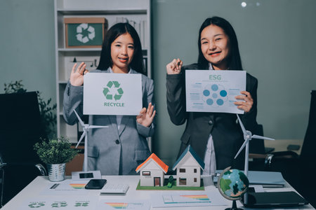 Business team people planning and discussing on recycle reduce reuse policy symbol in office meeting room.の写真素材