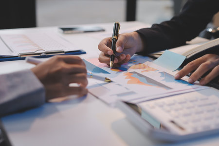 Team of business people working together in the meeting room office, teamwork background charts and...