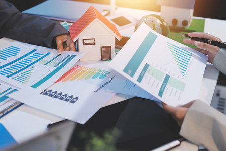 Asian woman lead young group of multiethnic businesspeople in team meeting, using laptop computer for ESG topic presentation on monitor. Sustainable business practice, people work at home conceptの写真素材