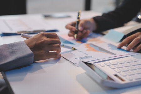 Team of business people working together in the meeting room office, teamwork background charts and...