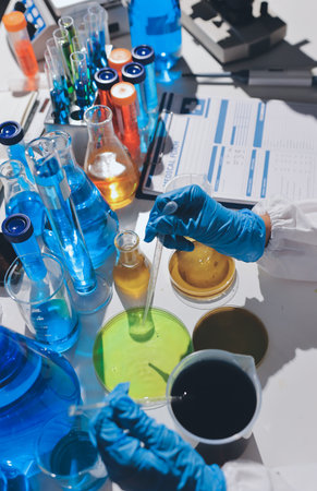Scientist pipetting medical samples into microplate in laboratoryの写真素材