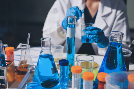 Scientist pipetting medical samples into microplate in laboratoryの写真素材