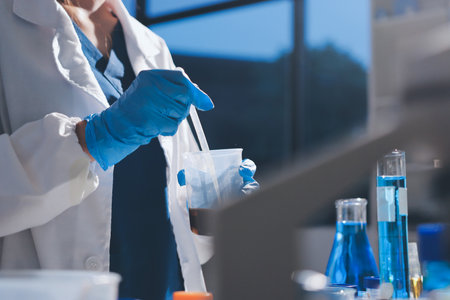Scientist pipetting medical samples into microplate in laboratoryの写真素材