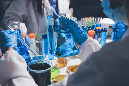 Scientist pipetting medical samples into microplate in laboratoryの写真素材