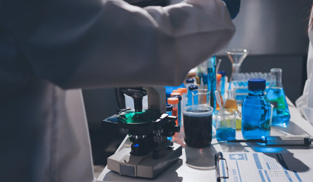 Scientist pipetting medical samples into microplate in laboratory
