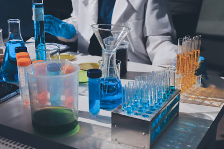 Scientist pipetting medical samples into microplate in laboratory