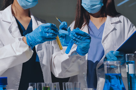 Scientist pipetting medical samples into microplate in laboratoryの写真素材