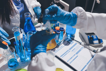 Scientist pipetting medical samples into microplate in laboratory