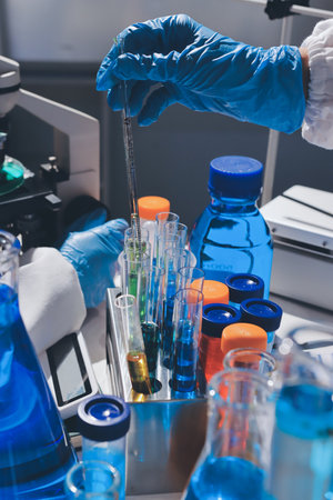 Scientist pipetting medical samples into microplate in laboratoryの写真素材