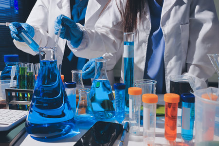 Scientist pipetting medical samples into microplate in laboratoryの写真素材