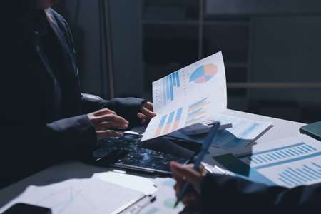 Group of business women working on a financial data expenses document.の写真素材