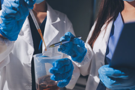 Scientist pipetting medical samples into microplate in laboratoryの写真素材