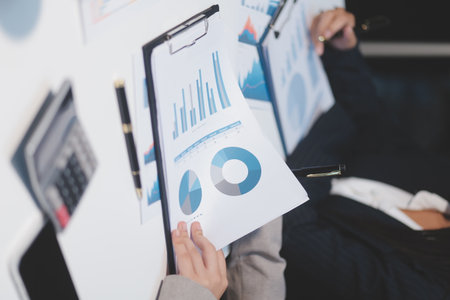 Close up of Business team analyzing income charts and graphs with modern laptop computer. Business analysis and strategy concept.の写真素材